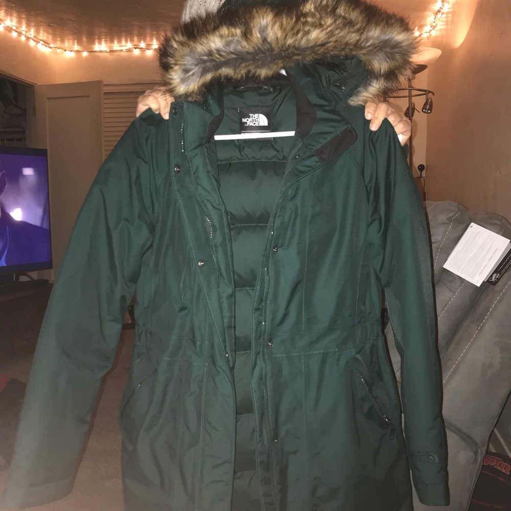 Dark green NORTH FACE trench coat.